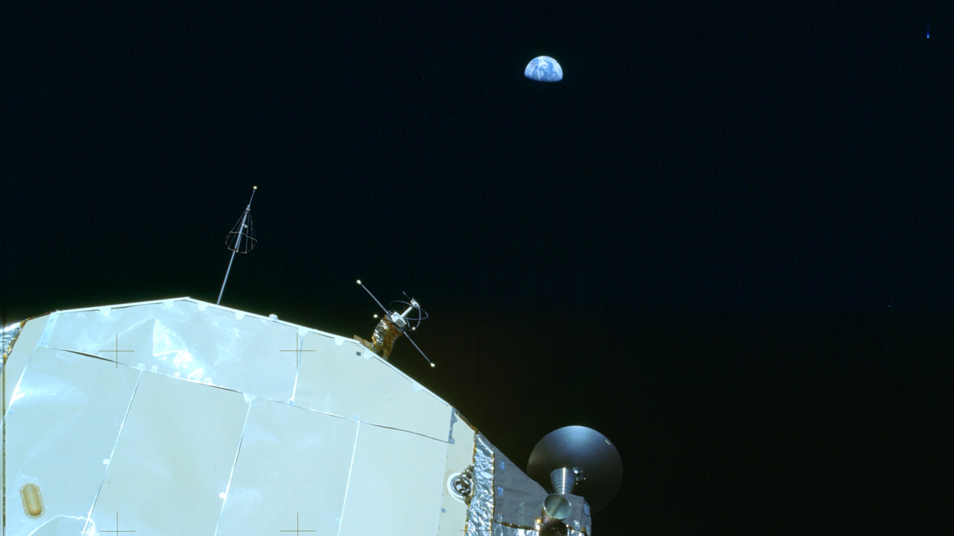 The Apollo Command and Service Module, the Earth rising small over the black of space